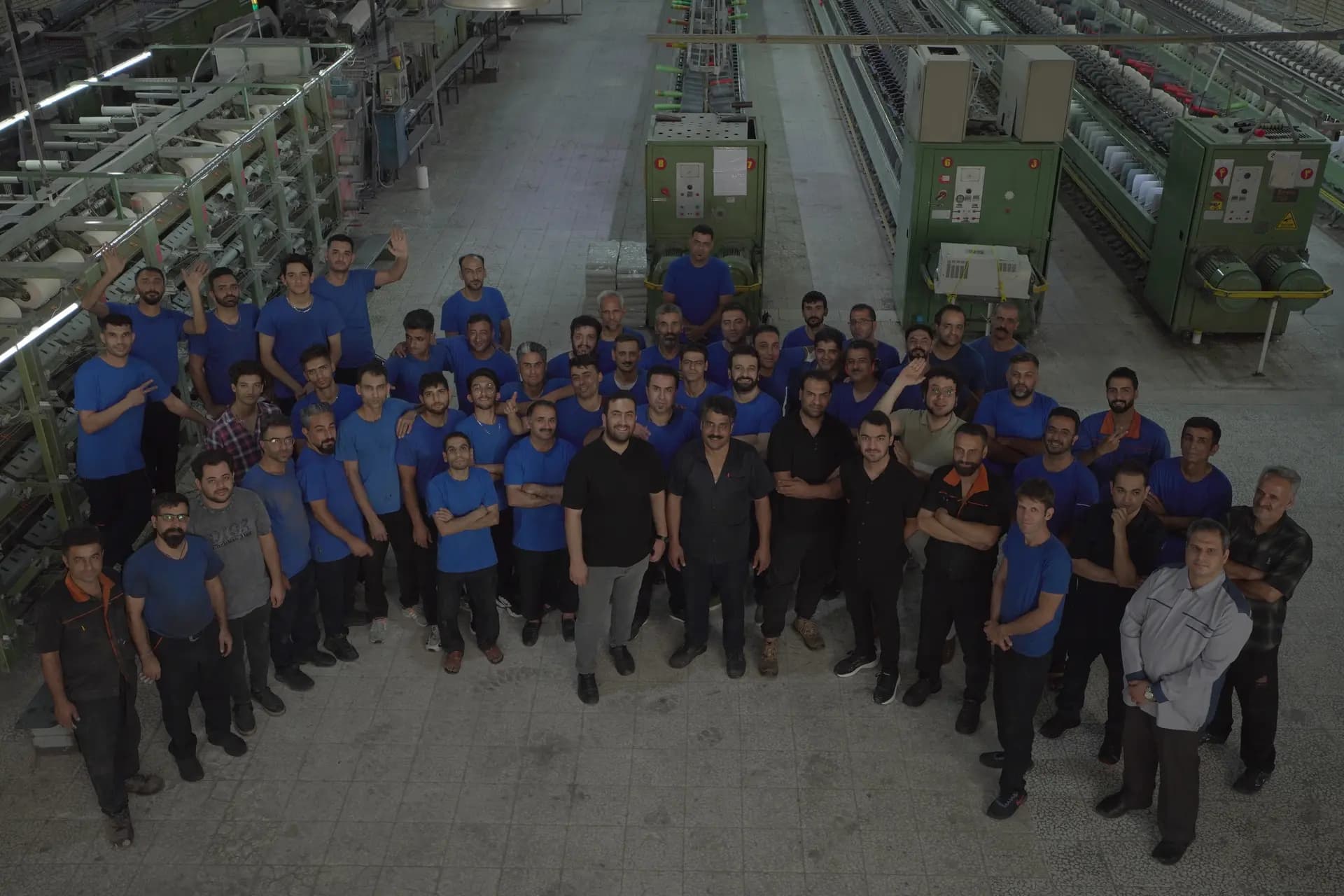 Production staff of Bayer Kashan Spinning posing in the factory hall